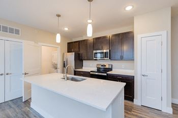 a kitchen with a large white counter top at The Flats at Summit Station, South Park, 15129